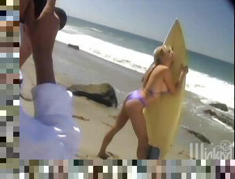 Pleasurable blonde with huge boobs poses on a beach
