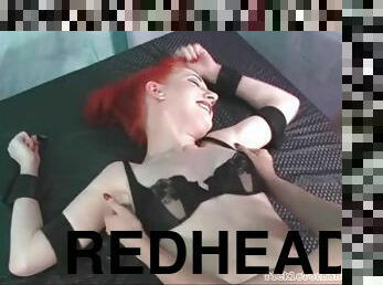 Redhead in bondage tickled