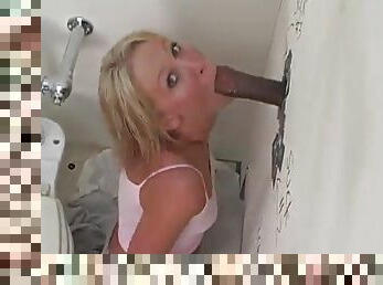Ashley Moore clamps her mouth down on a big black cock in a gloryhole