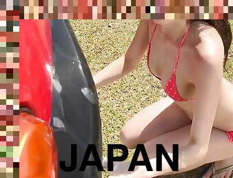 Polka dot bikini cutie washes the car