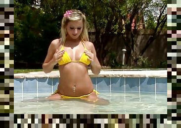 Watch this extremely hot blonde babe having fun by the pool