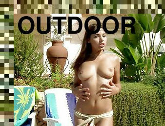 Solo bikini girl Zafira strips outdoors and masturbates tenderly