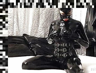 Rubberdoll in black latex enclosure 