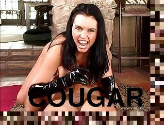 Leather-clad cougar with long dark hair playing with a stranger's big cock