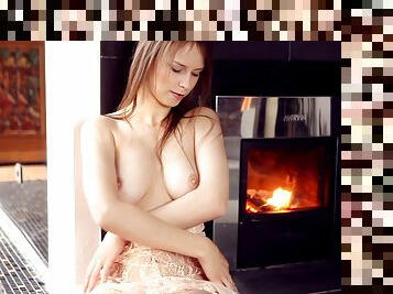 Beautiful Beata Undine fingers herself in front of the fireplace