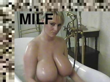 Angelic solo model with big tits posing lovely in the bath tab