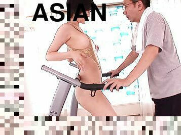 While walking on a treadmill this Asian hottie gets fucked from behind