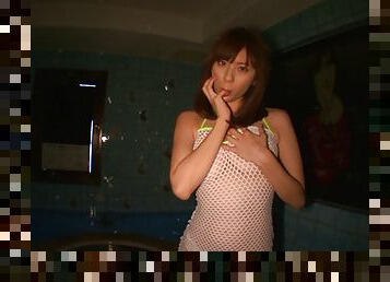 Japanese Yuma Asami in fishnet enjoys oiling her body in a solo scene