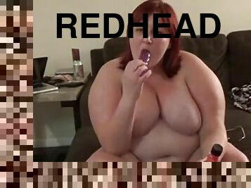 Obese redhead bitch fucks her pussy with a dildo indoors