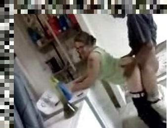 Amateur blond wearing glasses enjoys interracial rear sex in a kitchen