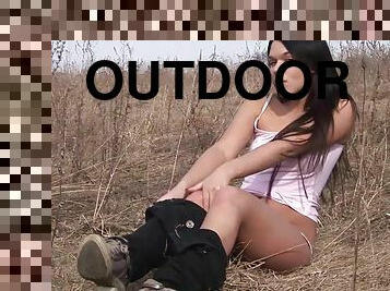 Claudia masturbates her pussy with a realistic dildo outdoors