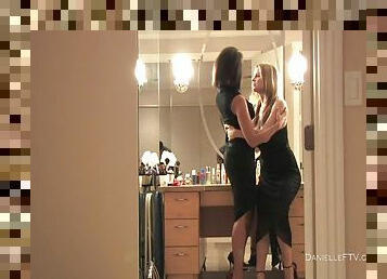 Two gorgeous babes in black dresses fuck in a wardrobe