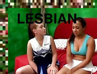 Two teen lesbians toy their pussies in a bedroom