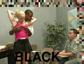 Slim blonde gets fucked by a black stud in the presence of a voyeur