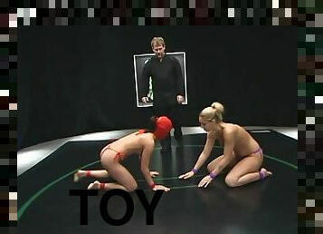 Nasty chick in red mask toys a blonde girl and sits on her face