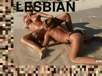 Two blonde lesbians make out and lick each other's vags on a beach