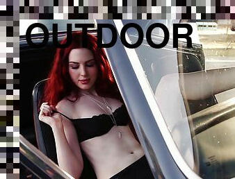 Redhead Alyssa Michelle poses in lingerie in a car