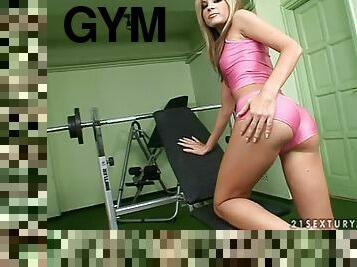Laura King plays with her nice smooth pussy in a gym