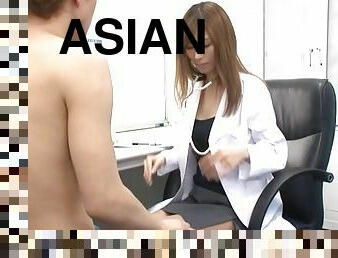 A sexy Asian doctor sprawls out on the desk and gets fucked