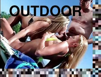 Fooling around outdoors with two bikini babes