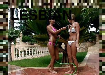 Kinky ladies have lesbian sex outdoors with a water hose