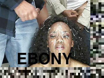 Wavy haired ebony cowgirl's face gets buried under a load of cum at a steamy bukkake party