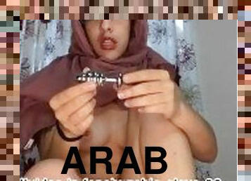Arab with hijab on stretches using anal toys