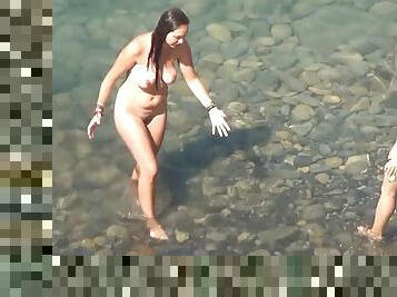 Sweet naked babes are playing in the water