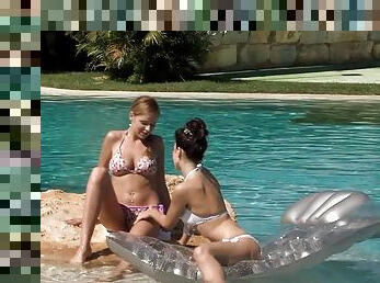 Seductive lesbian in a bikini enjoys an erotic lovemaking outdoors