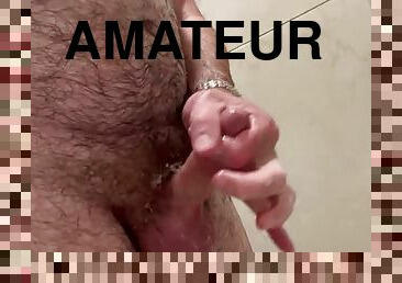 Handjob after training in the gym shower with cumshot in front of the camera