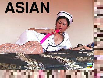 Solo Asian nurse in a hotel room fucks a big pink dildo