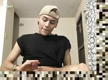 Latin twink teasing ass and stroking his pecker indoors