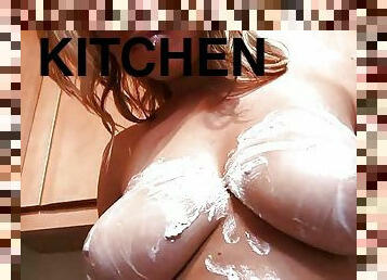 Kitchen slut Kylie plays with whipped cream on her bare breasts