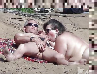 Blowjob on a nudist beach.