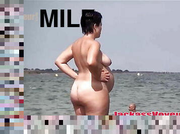 Nude pregnant MILF on the beach