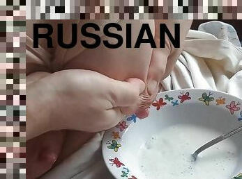 Russian MILF drains lactation milk into a plate