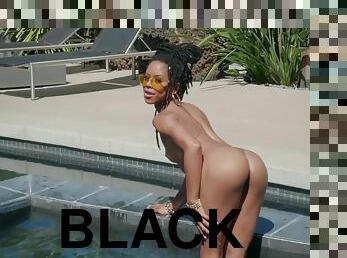 Black beauty Kira Noir strips and plays with her pussy in the pool