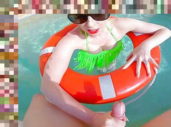 Beautiful busty redhead mature is out in the pool in her green bikini