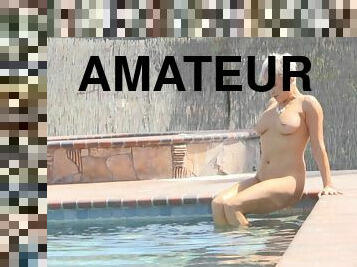 Ryan exposes her huge tits and takes a naked swim in the pool
