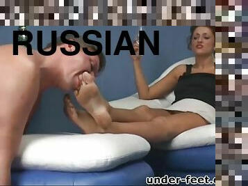 Russian doll drinking while her toes gets licked in femdom porn
