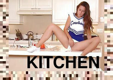 Sexy Cheerleader Bridget Bond rubbing her pussy in kitchen