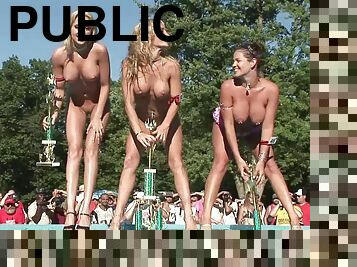 Fake tits models stripteasing seductively in public outdoor