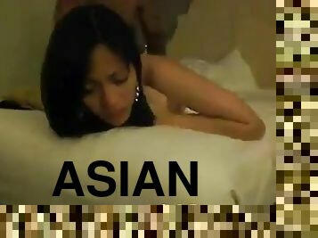 An exotic-looking Asian slut gets rammed by an ebony dude in various positions