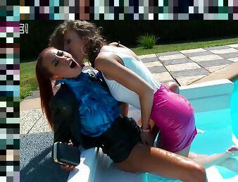 Dressed women hook up for a lesbian shag in a swimming pool