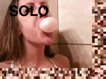 Adorable Marie Madison bubbles chewing gum in solo model reality scene