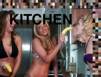Kimberly, Samantha and Sophia play with a banana in the kitchen