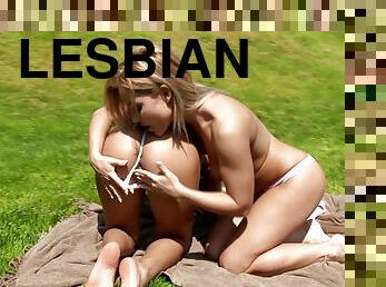 Two palatable sapphic divas make love lying on the grass