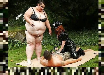 Mistress and her SSBBW friend fuck a submissive slave guy outdoors
