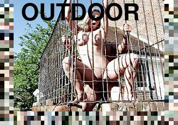 Blonde in a cage outdoors for a furious hardcore fucking