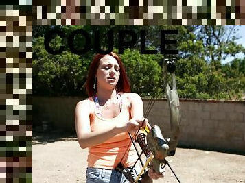 Redhead shooting a bow and arrow and fucking a horny guy